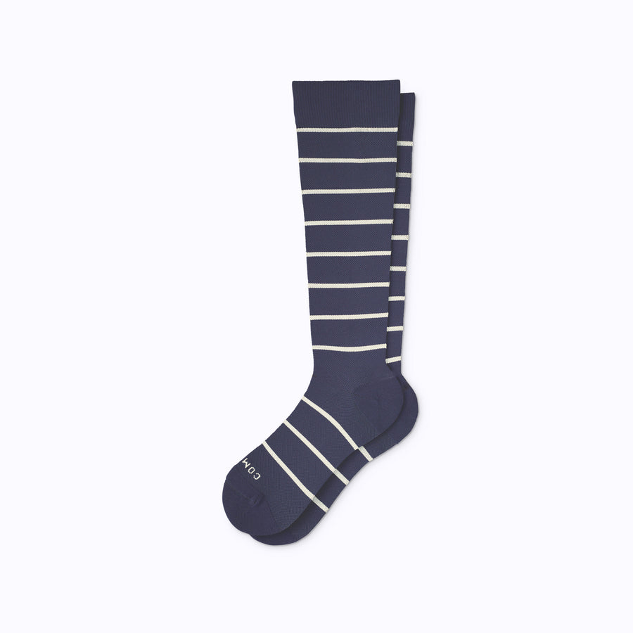 A pair of nylon knee high socks in navy-sand stripes