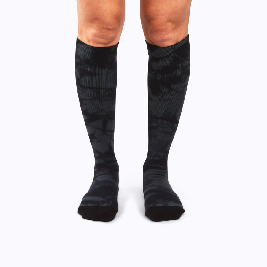 Front view of legs wearing a nylon knee high compression socks in black twist-dye