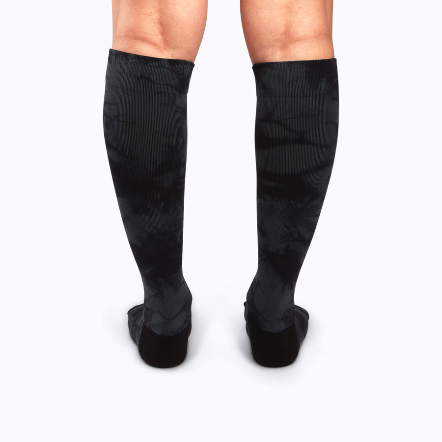 Back view of legs wearing a nylon knee high compression socks in black twist